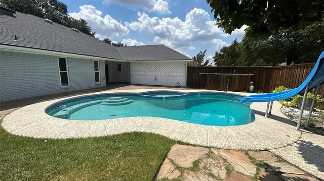 a view of a swimming pool with a small yard