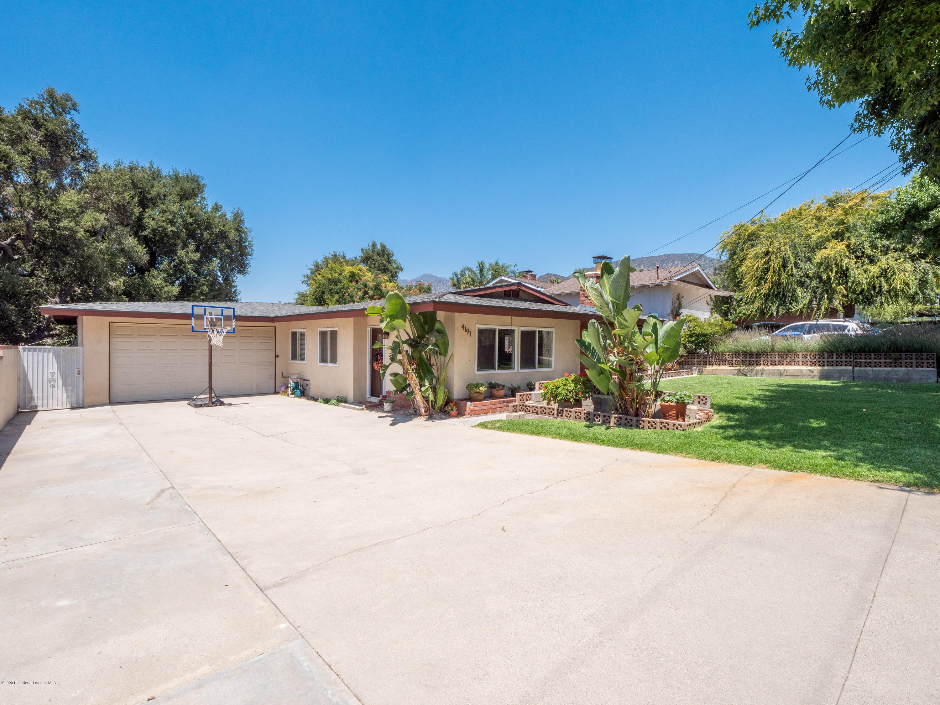 4191 Aralia Road Altadena, CA 91001 - Photo 2 of 26 a front view of house with yard and car parked