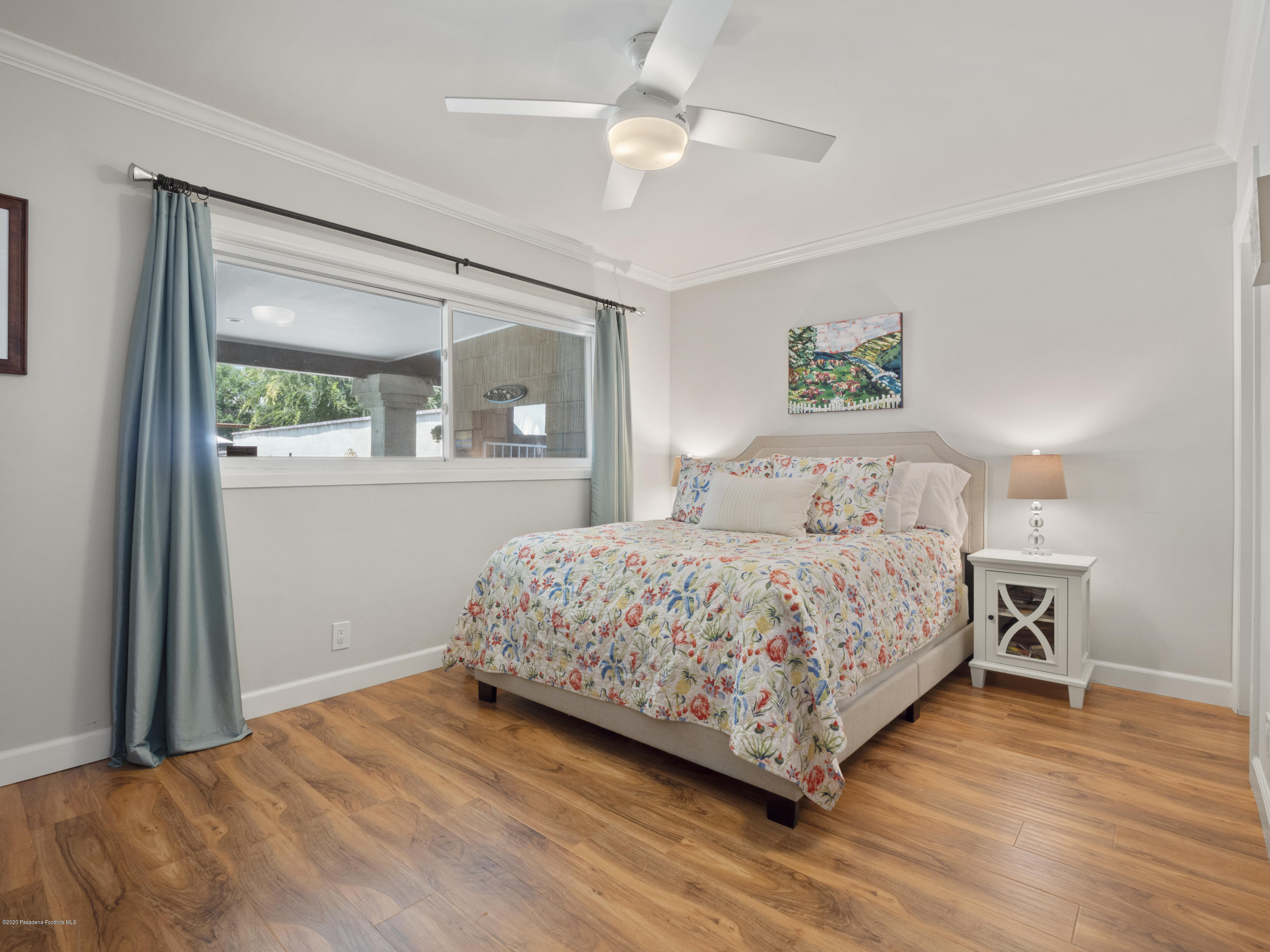 4191 Aralia Road Altadena, CA 91001 - Photo 15 of 26 a bedroom with a large bed and a chandelier