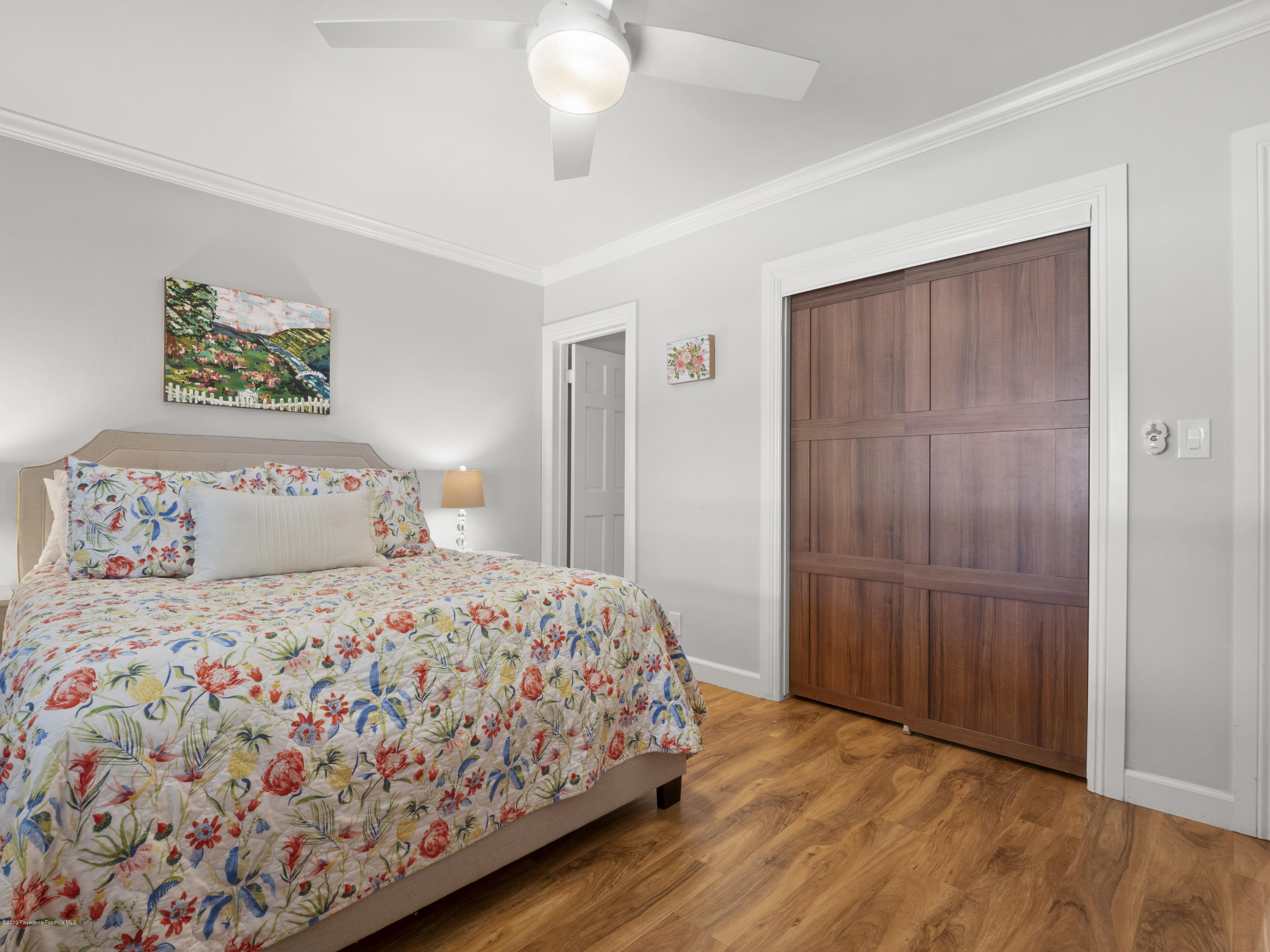 4191 Aralia Road Altadena, CA 91001 - Photo 16 of 26 a bedroom with a bed and a chandelier