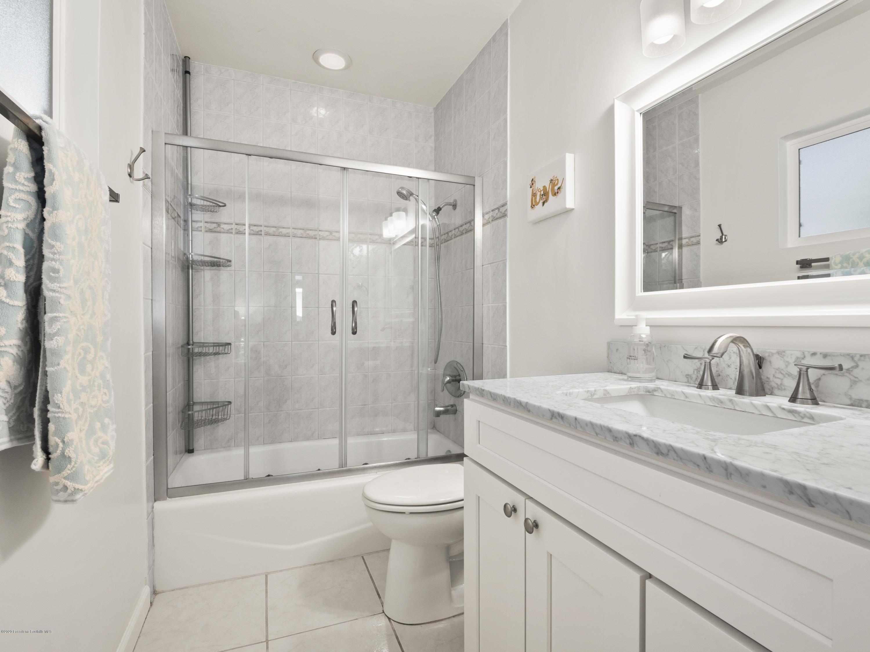 4191 Aralia Road Altadena, CA 91001 - Photo 17 of 26 a bathroom with a granite countertop sink a toilet and shower