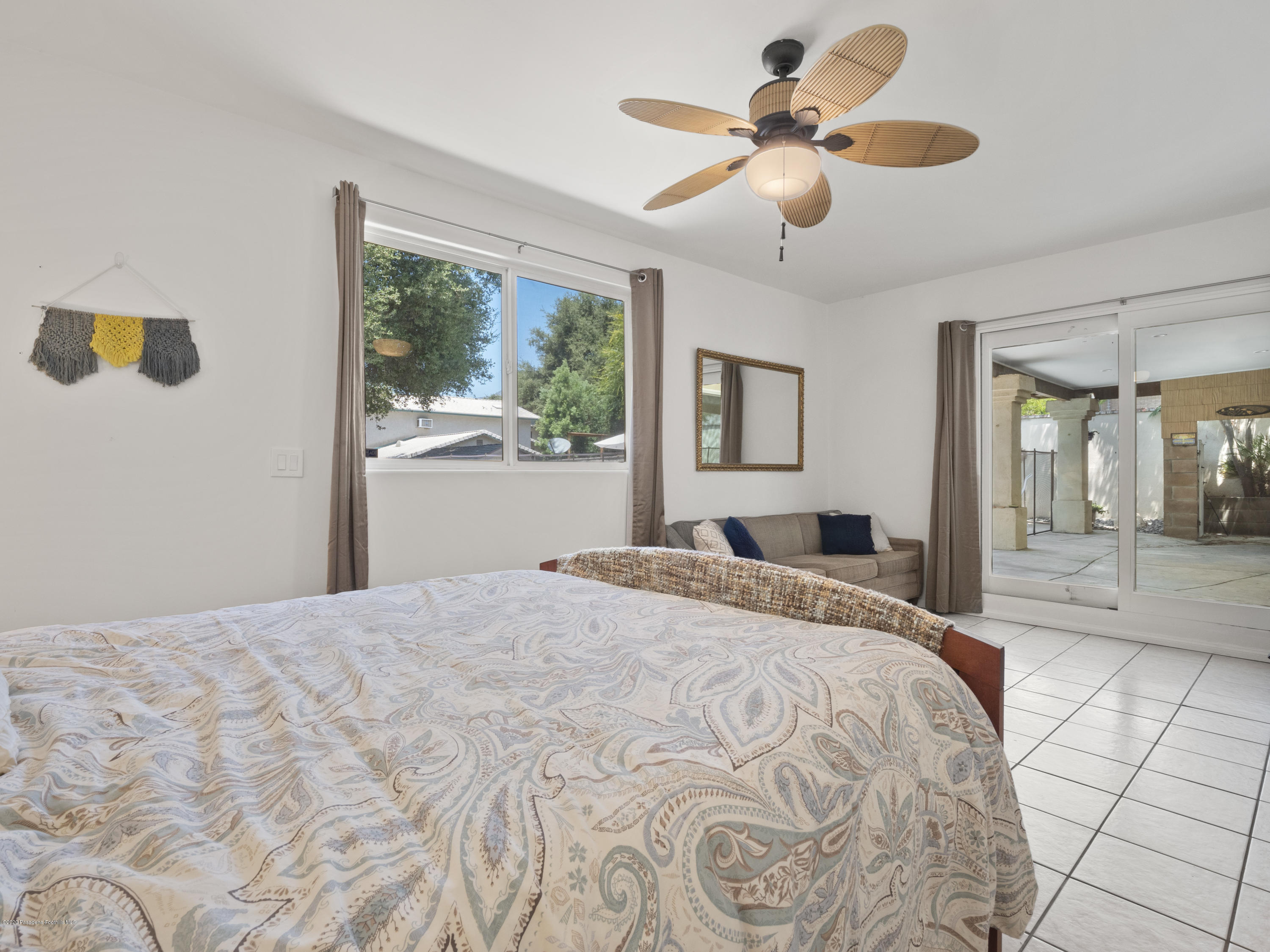 4191 Aralia Road Altadena, CA 91001 - Photo 18 of 26 a bedroom with a bed and a chandelier
