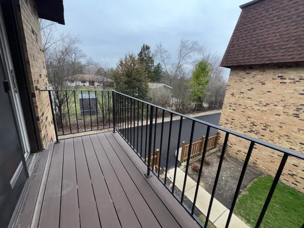 a view of balcony with wooden floor