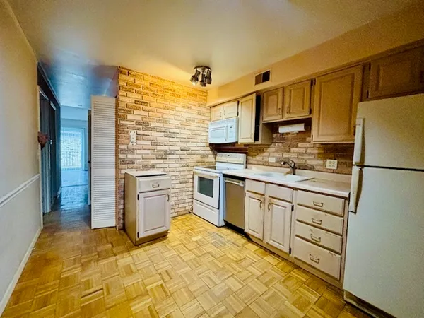 a kitchen with stainless steel appliances granite countertop a refrigerator sink stove and microwave