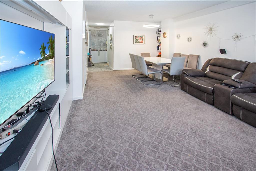 1720 East 14th Street, Unit 4A Brooklyn, NY 11229 - Photo 2 of 13 a living room with furniture and a flat screen tv