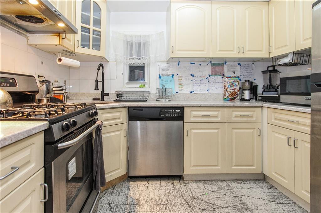 1720 East 14th Street, Unit 4A Brooklyn, NY 11229 - Photo 4 of 13 a kitchen with white cabinets and appliances