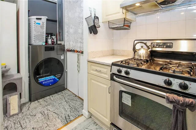 a kitchen with stainless steel appliances granite countertop a stove and a wooden cabinets
