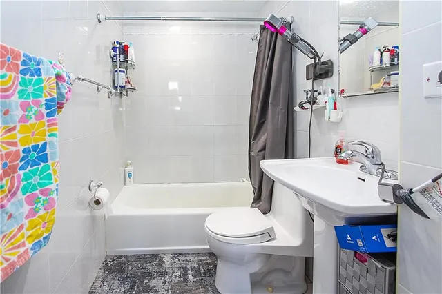 a bathroom with a sink toilet and bathtub