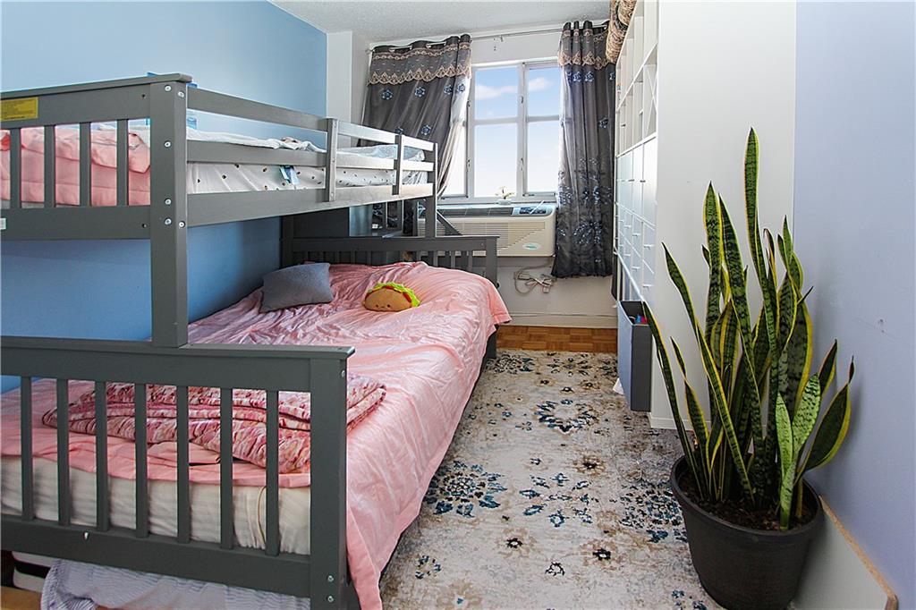 1720 East 14th Street, Unit 4A Brooklyn, NY 11229 - Photo 10 of 13 a bedroom with a bed next to a window with potted plants