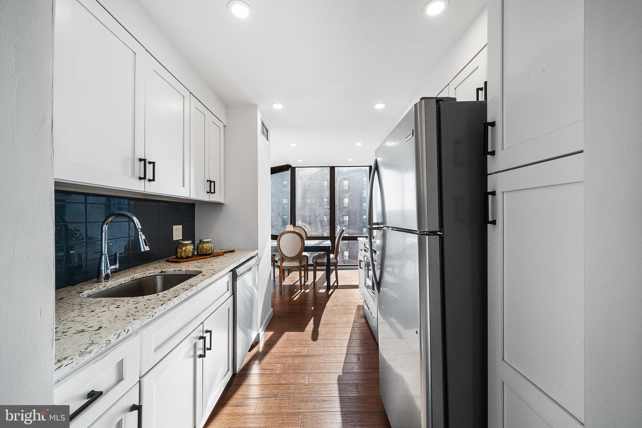 2018 Walnut Street, Unit 16E Philadelphia, PA 19103 - Photo 15 of 35 a kitchen with stainless steel appliances granite countertop a refrigerator a stove top oven a sink and dishwasher