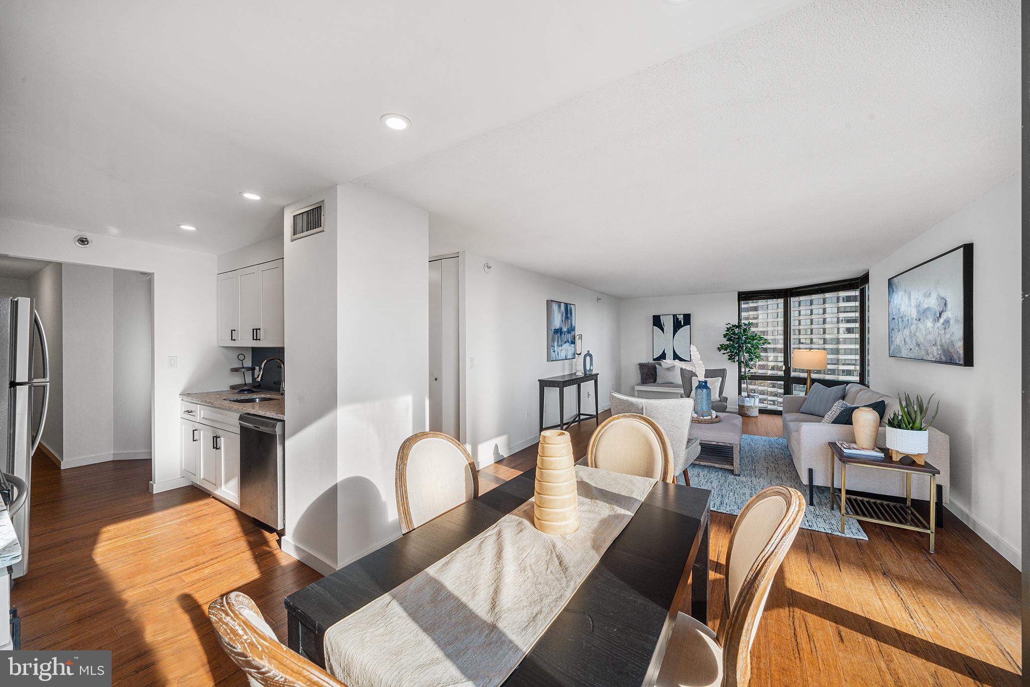 2018 Walnut Street, Unit 16E Philadelphia, PA 19103 - Photo 16 of 35 a living room with furniture a flat screen tv and kitchen view