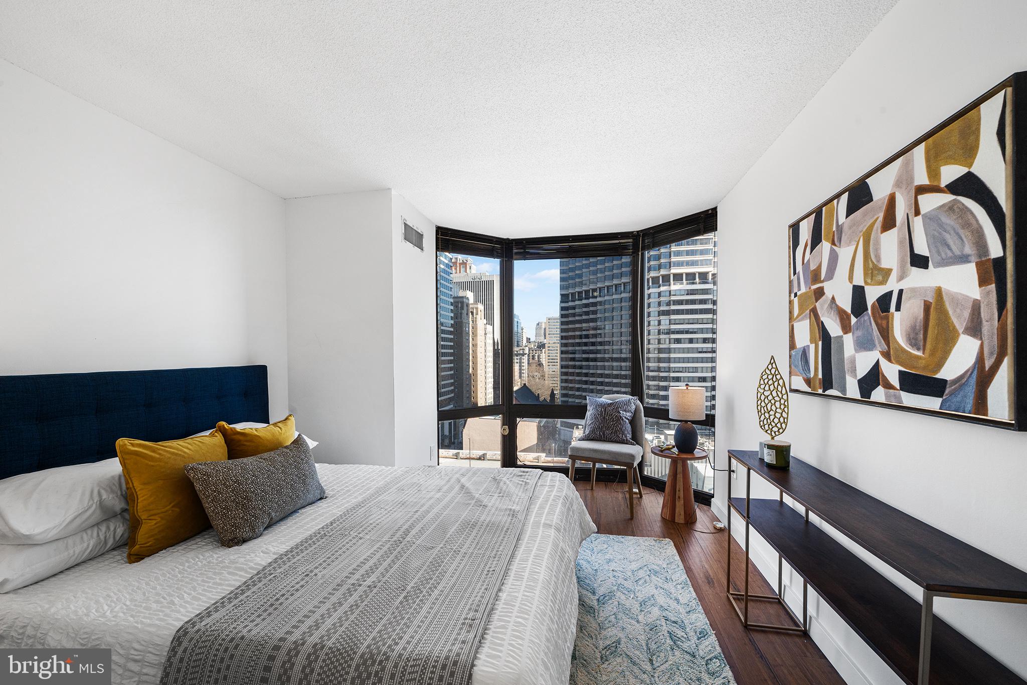 2018 Walnut Street, Unit 16E Philadelphia, PA 19103 - Photo 19 of 35 a bedroom with a bed and furniture with window