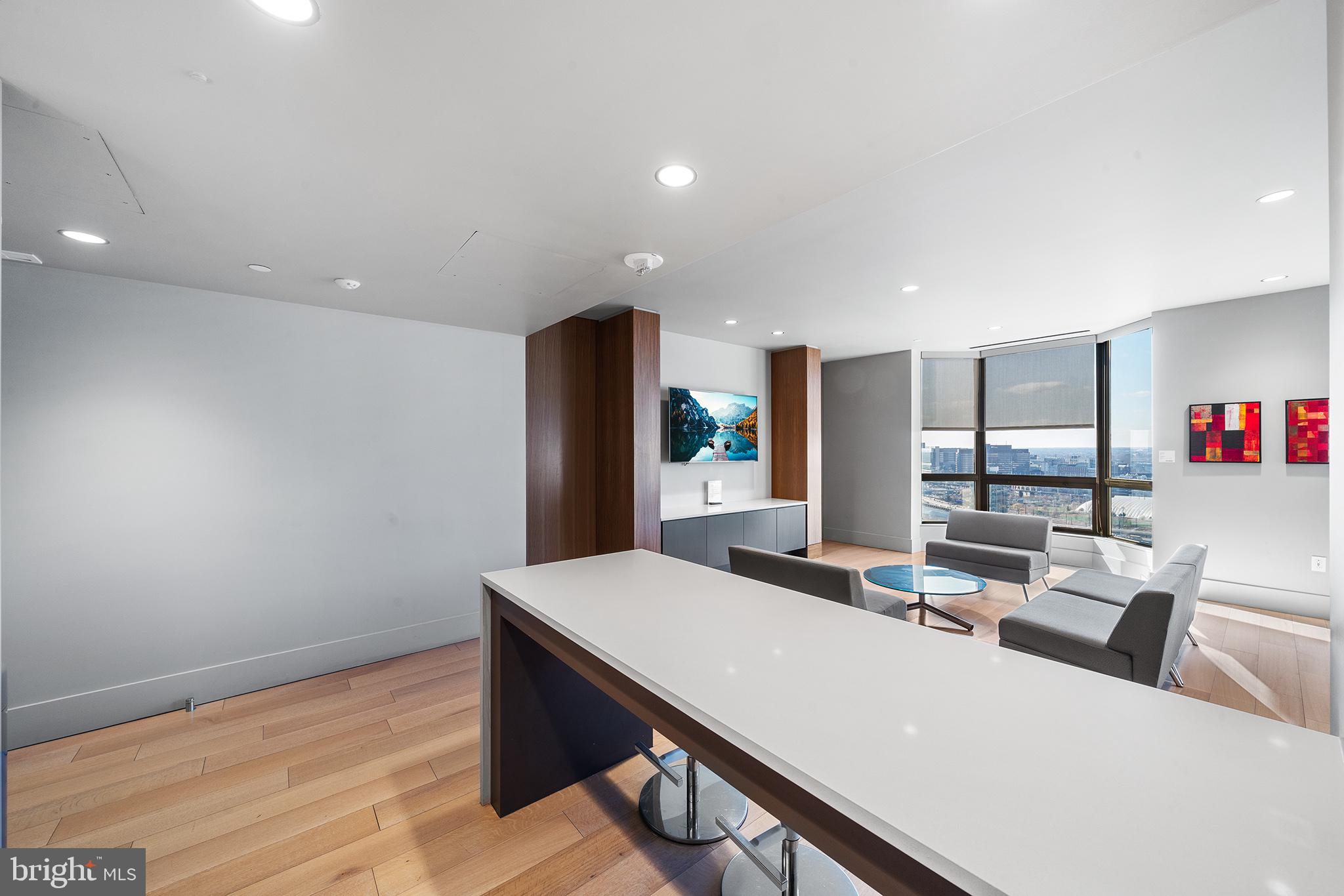 2018 Walnut Street, Unit 16E Philadelphia, PA 19103 - Photo 32 of 35 a living room with stainless steel appliances kitchen island a table and chairs in it