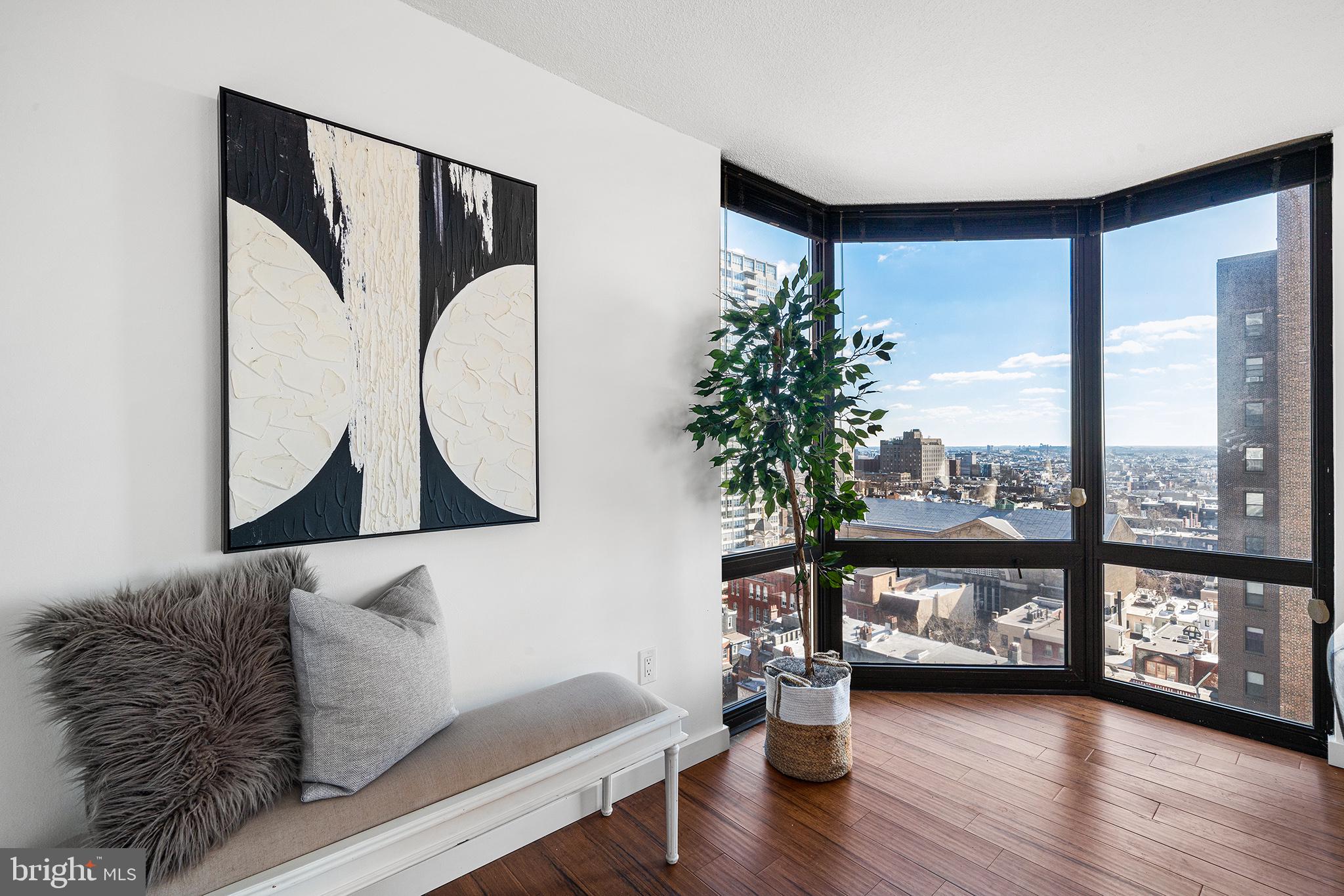 2018 Walnut Street, Unit 16E Philadelphia, PA 19103 - Photo 4 of 35 a living room with furniture and a floor to ceiling window