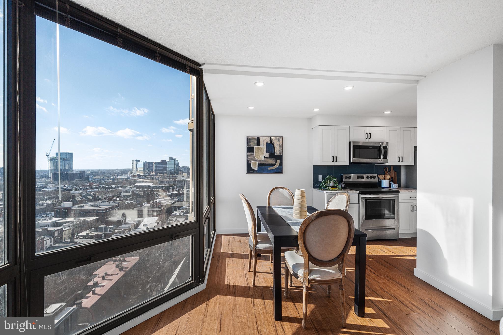 2018 Walnut Street, Unit 16E Philadelphia, PA 19103 - Photo 9 of 35 a living room with stainless steel appliances furniture a rug and a view of kitchen