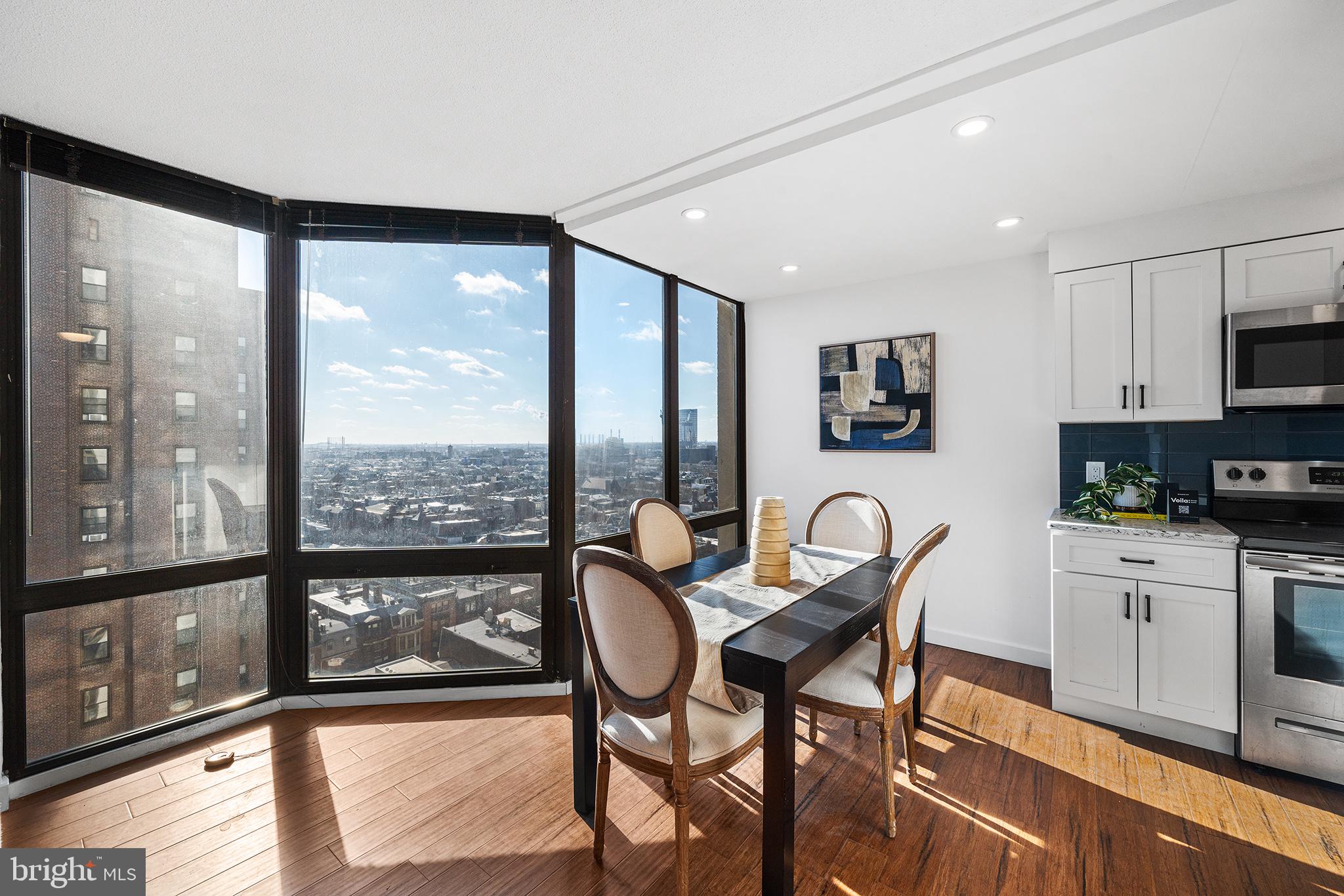 2018 Walnut Street, Unit 16E Philadelphia, PA 19103 - Photo 10 of 35 a dining room with furniture and a floor to ceiling window