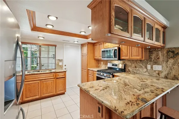 a kitchen with stainless steel appliances granite countertop a sink and cabinets
