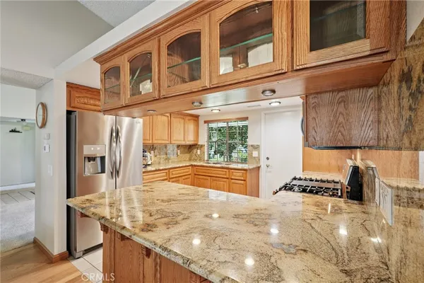 a kitchen with stainless steel appliances granite countertop a stove and a refrigerator