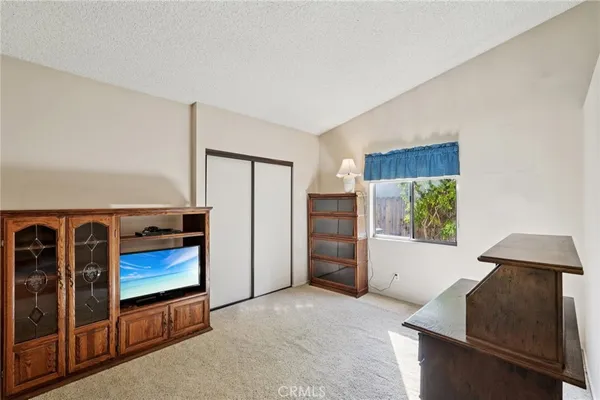 an empty room with furniture and a window