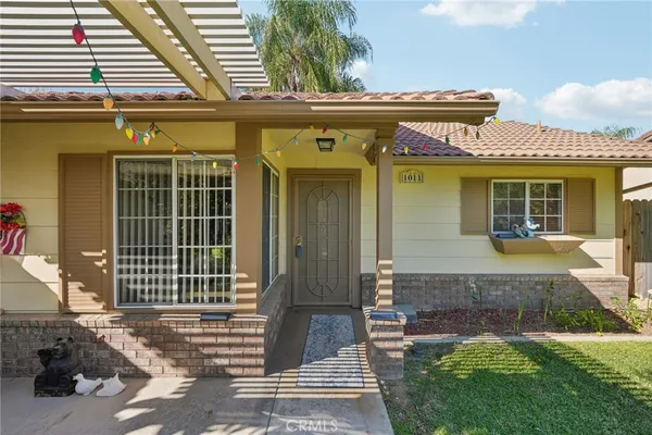 a front view of a house with a garden