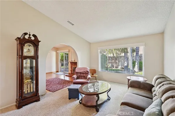 a living room with furniture fireplace and window