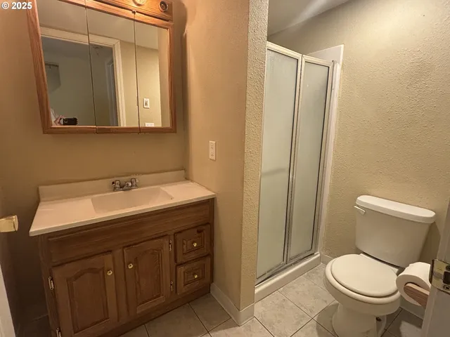 a bathroom with a toilet sink vanity and mirror