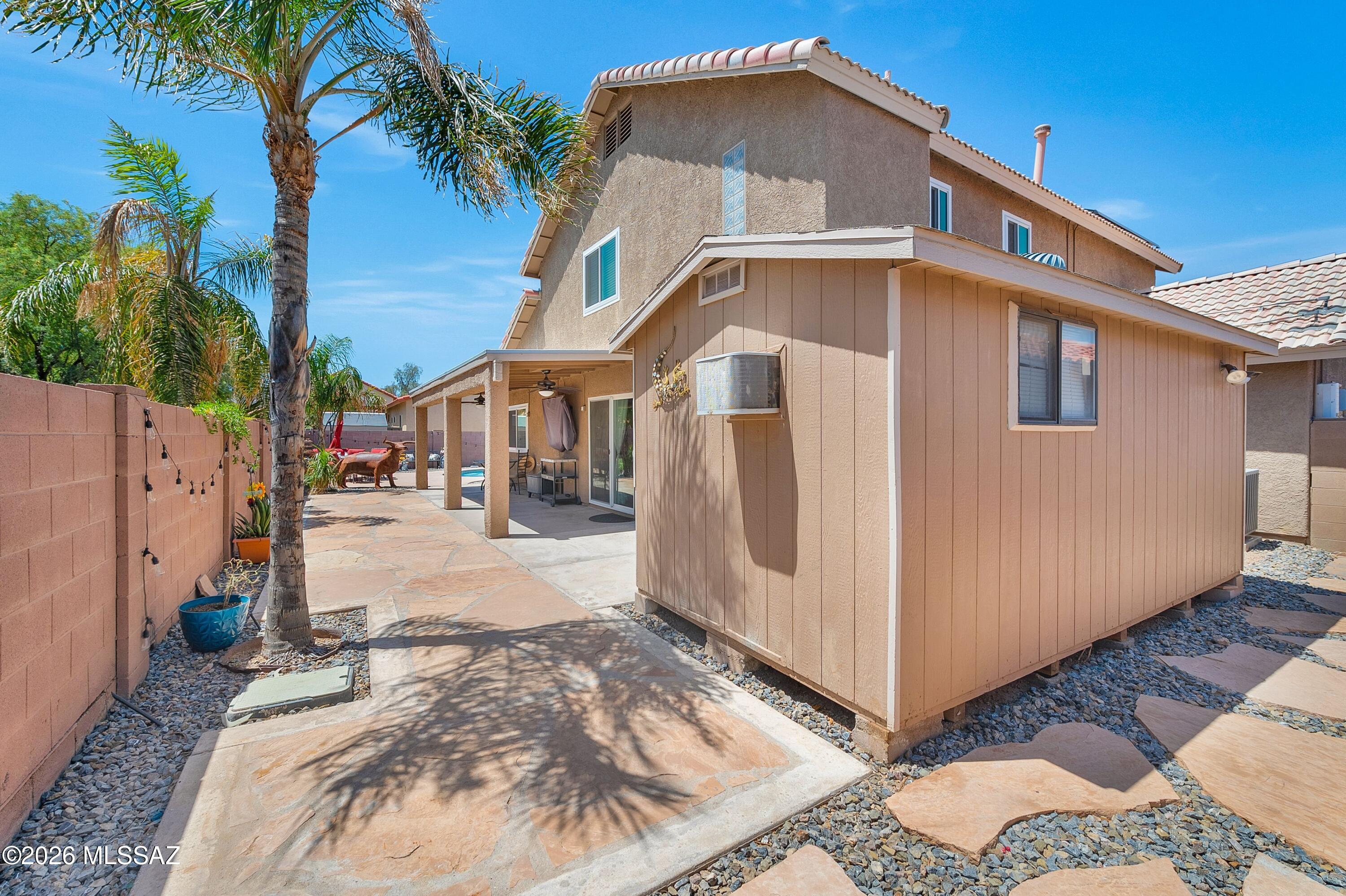 7159 West Maple Ridge Drive Tucson, AZ 85743 - Photo 26 of 42 a front view of a house with a yard
