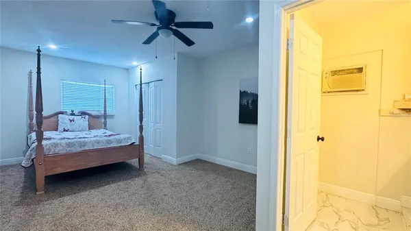 a bedroom with a bed and a mirror