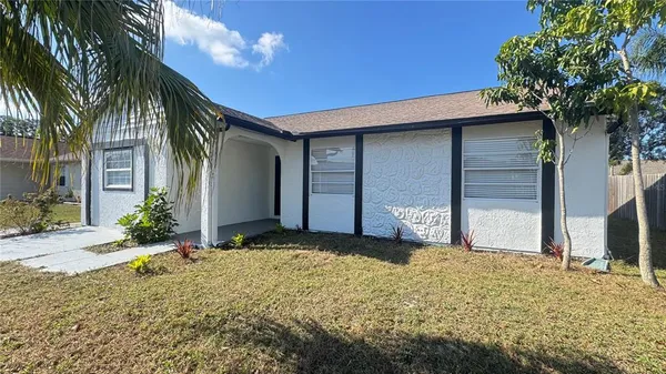 a front view of house with yard and trees