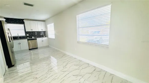a kitchen with a stove a sink and a refrigerator