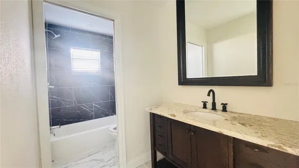 a bathroom with a sink a vanity and a mirror