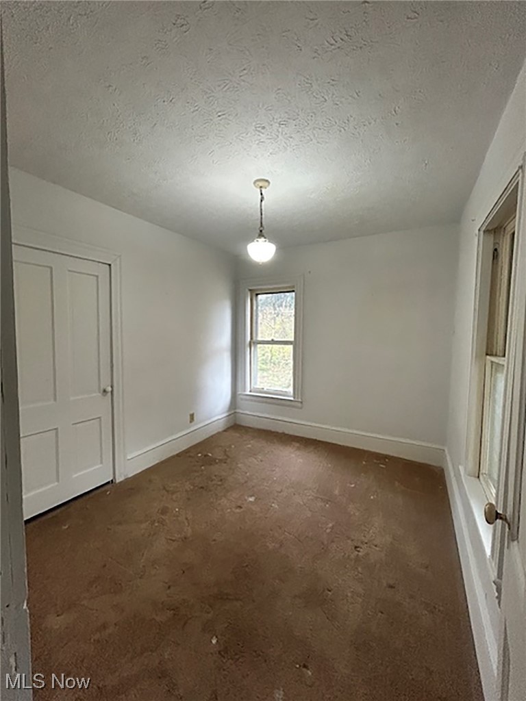 6128 Riverview Road Peninsula, OH 44264 - Photo 16 of 17 Unfurnished room featuring baseboards and a textured ceiling