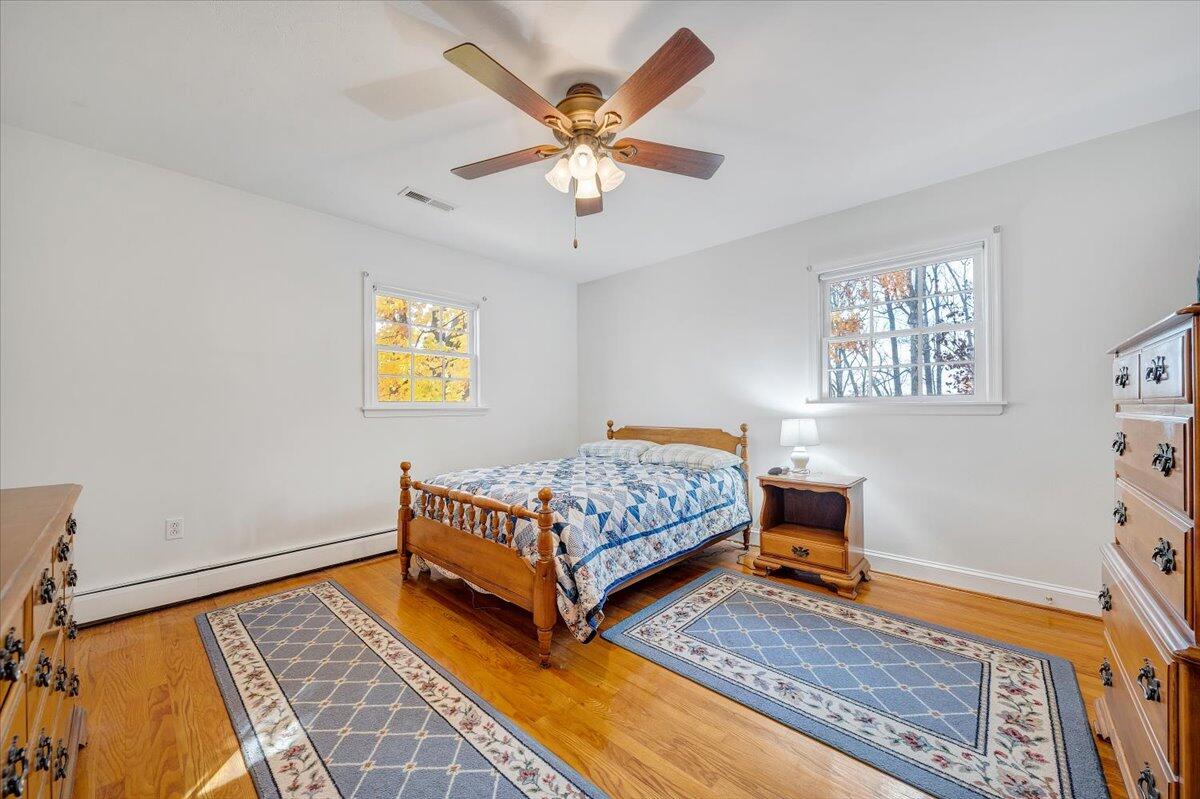 709 Olney Road Vinton, VA 24179 - Photo 14 of 41 a room with a bed and a chandelier