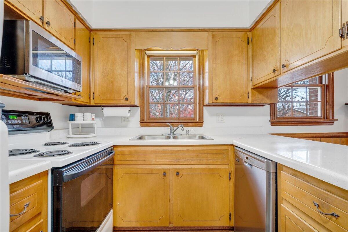 709 Olney Road Vinton, VA 24179 - Photo 8 of 41 a kitchen with stainless steel appliances a sink a stove and a refrigerator