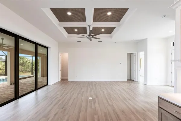 a large kitchen with a large window and stainless steel appliances