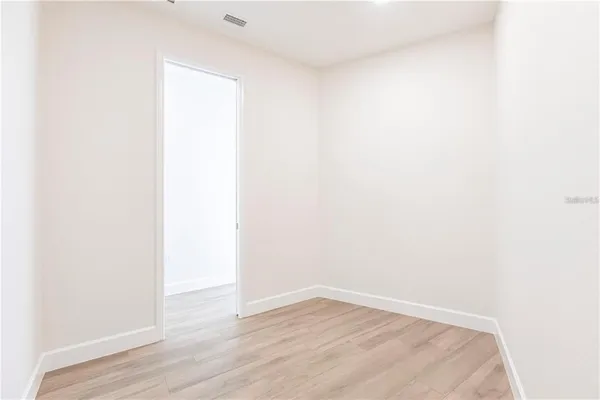 a view of an empty room and a window