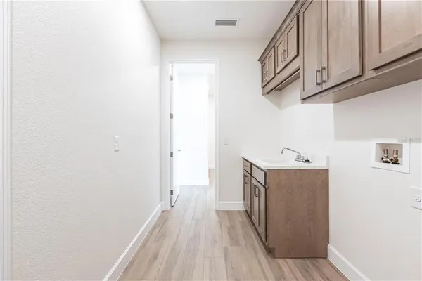an aerial view of a house with a garden and lake view