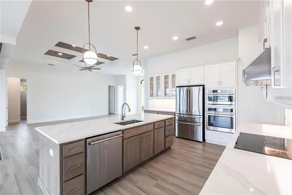 a kitchen with refrigerator cabinets and wooden floor