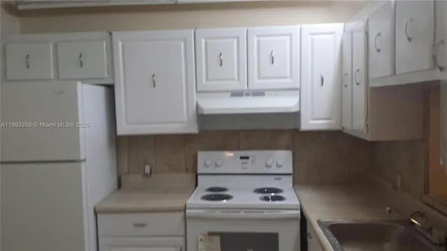 a kitchen with a stove and a refrigerator
