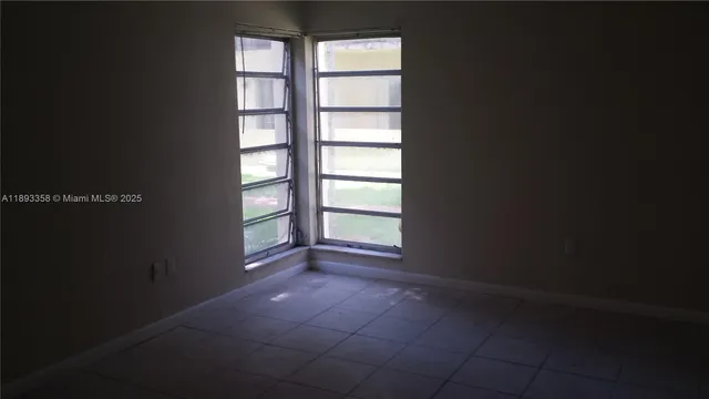 a view of empty room with windows