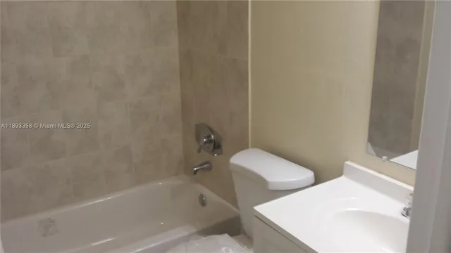 a white bath tub sitting next to a white toilet