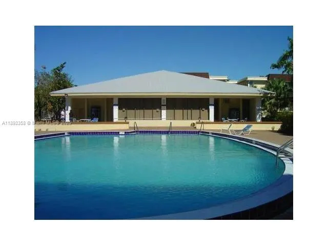 a living room with large pool table and chairs