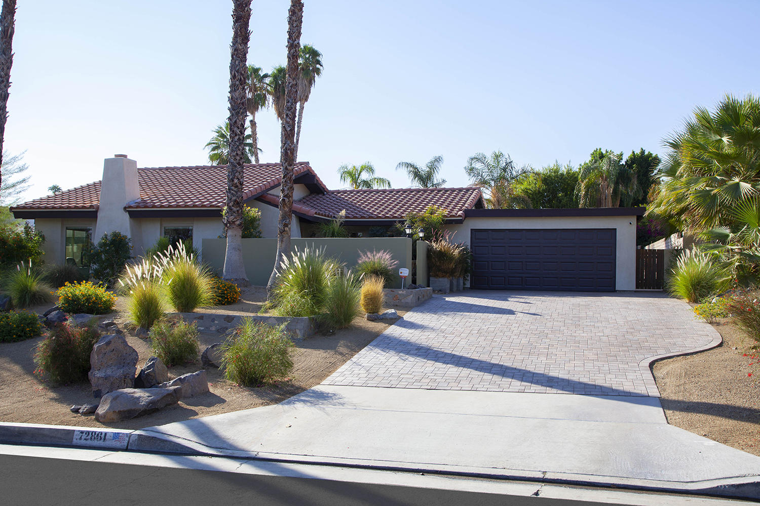 72861 Haystack Road Palm Desert, CA 92260 - Photo 1 of 45 a front view of a house with garden