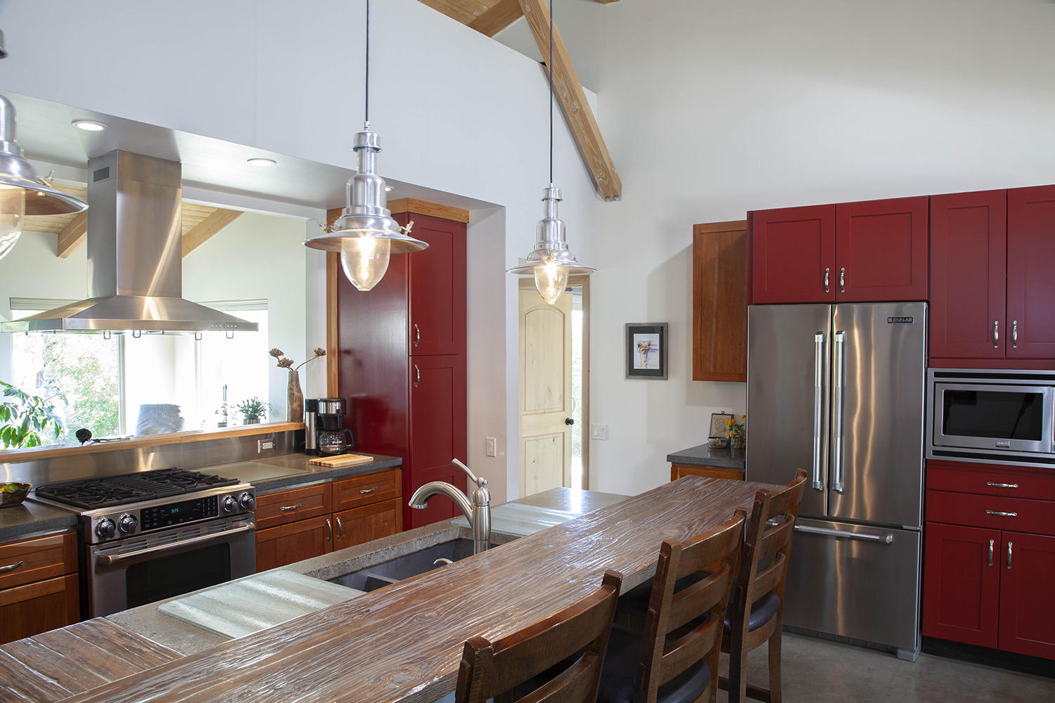 72861 Haystack Road Palm Desert, CA 92260 - Photo 18 of 45 a kitchen with a refrigerator a stove and a dining table with wooden floor