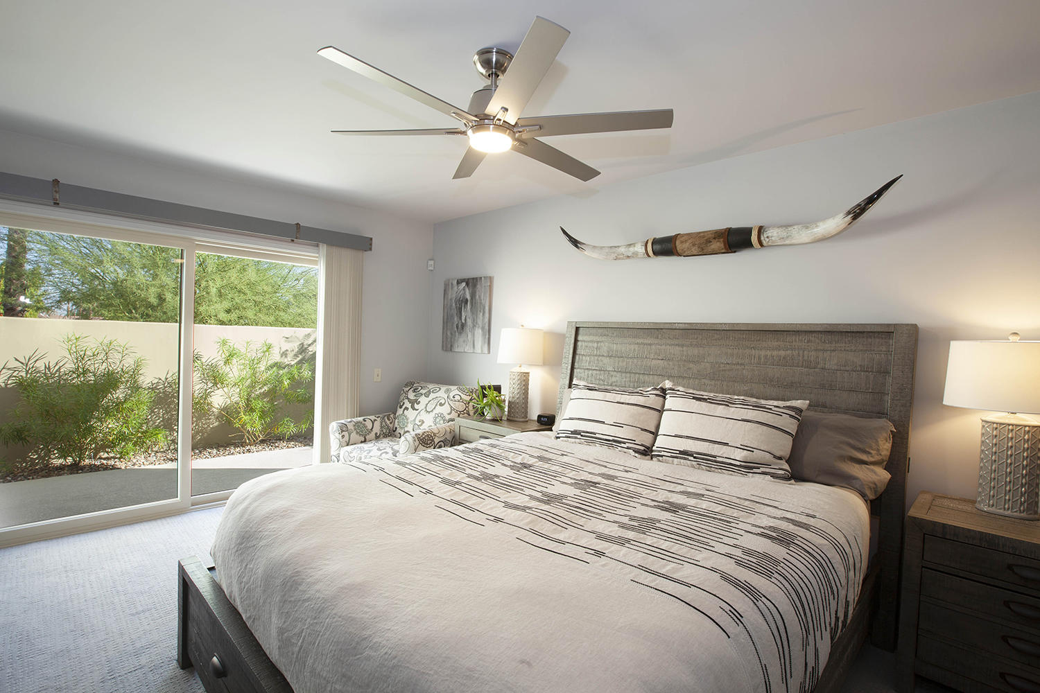 72861 Haystack Road Palm Desert, CA 92260 - Photo 27 of 45 a bedroom with a large bed and a large window