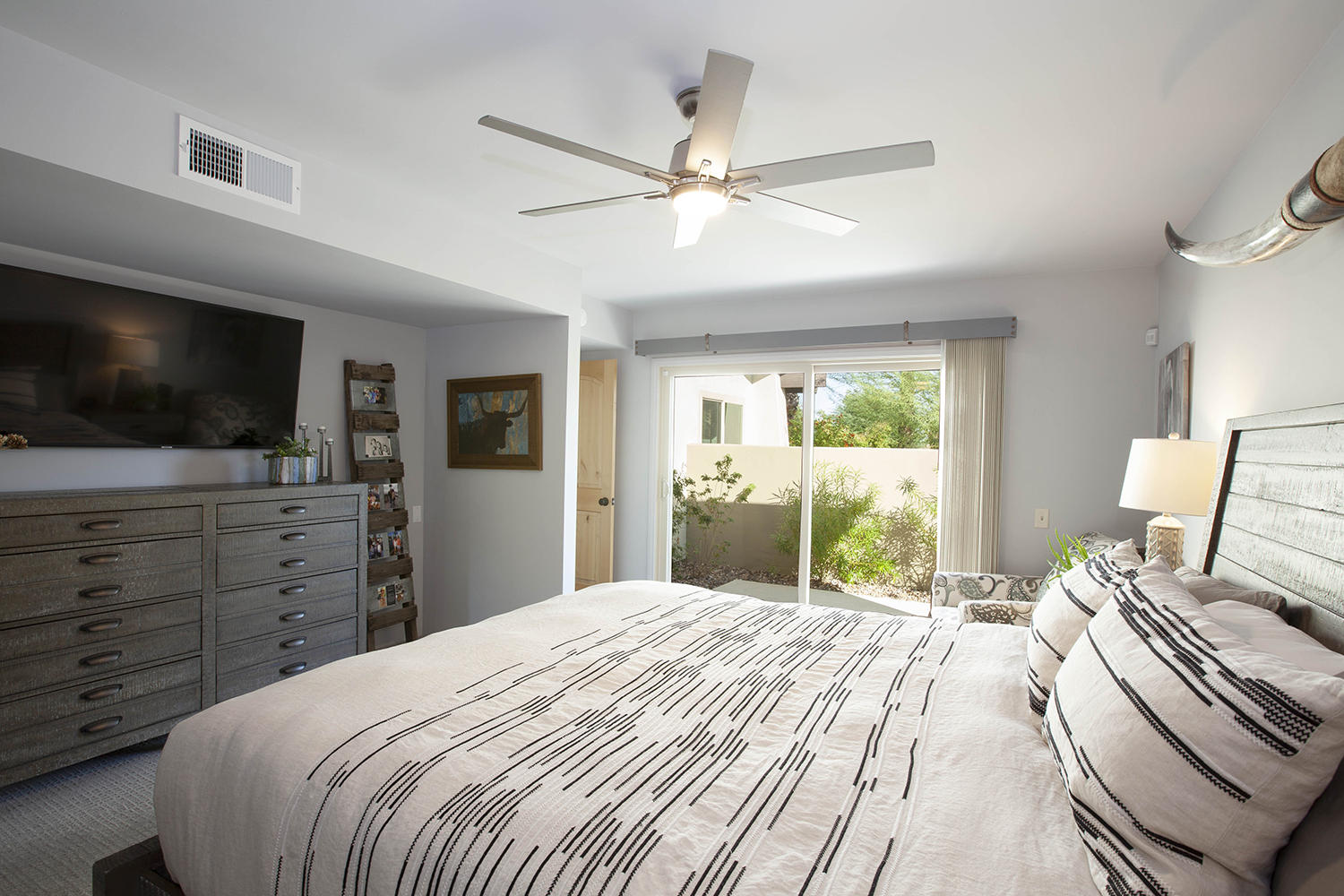 72861 Haystack Road Palm Desert, CA 92260 - Photo 28 of 45 a bedroom with a large bed and a flat screen tv