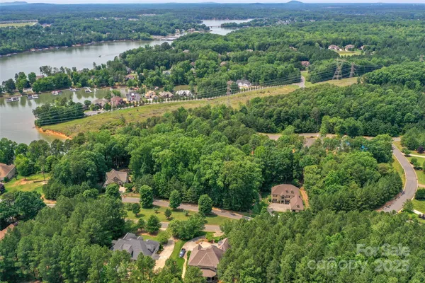 an aerial view of a house with yard and outdoor seating