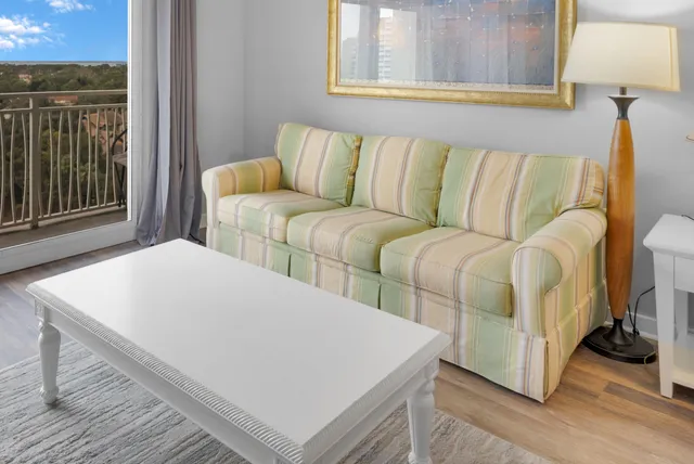 a living room with a couch and a dresser next to a window