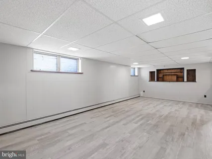 a view of a livingroom with wooden floor and windows