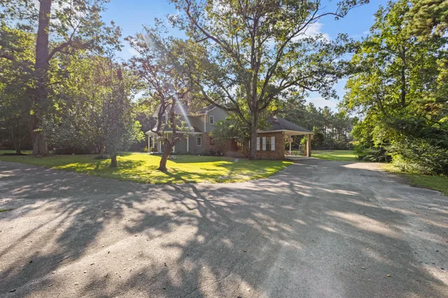 a view of a house with swimming pool and sitting area